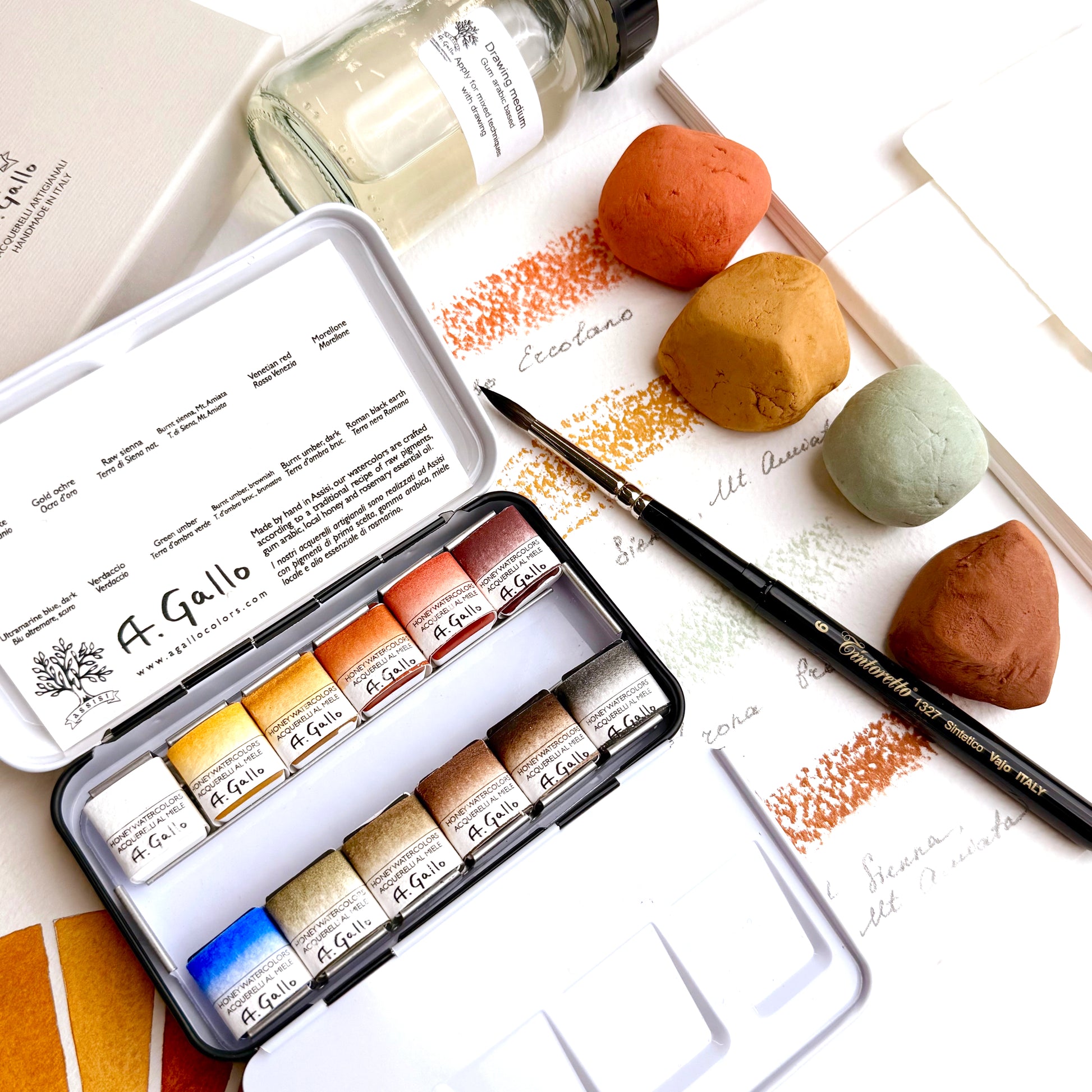 A Gallo watercolor paint set with a brush and color swatches on a white background