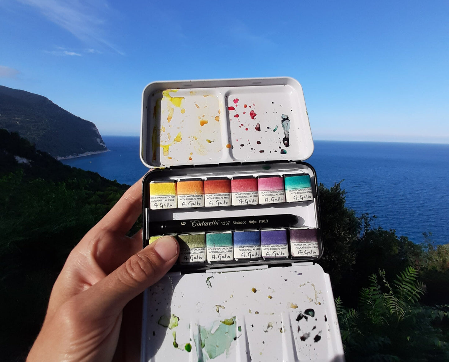 A. Gallo watercolor tin with paints overlooking the Italian coastline