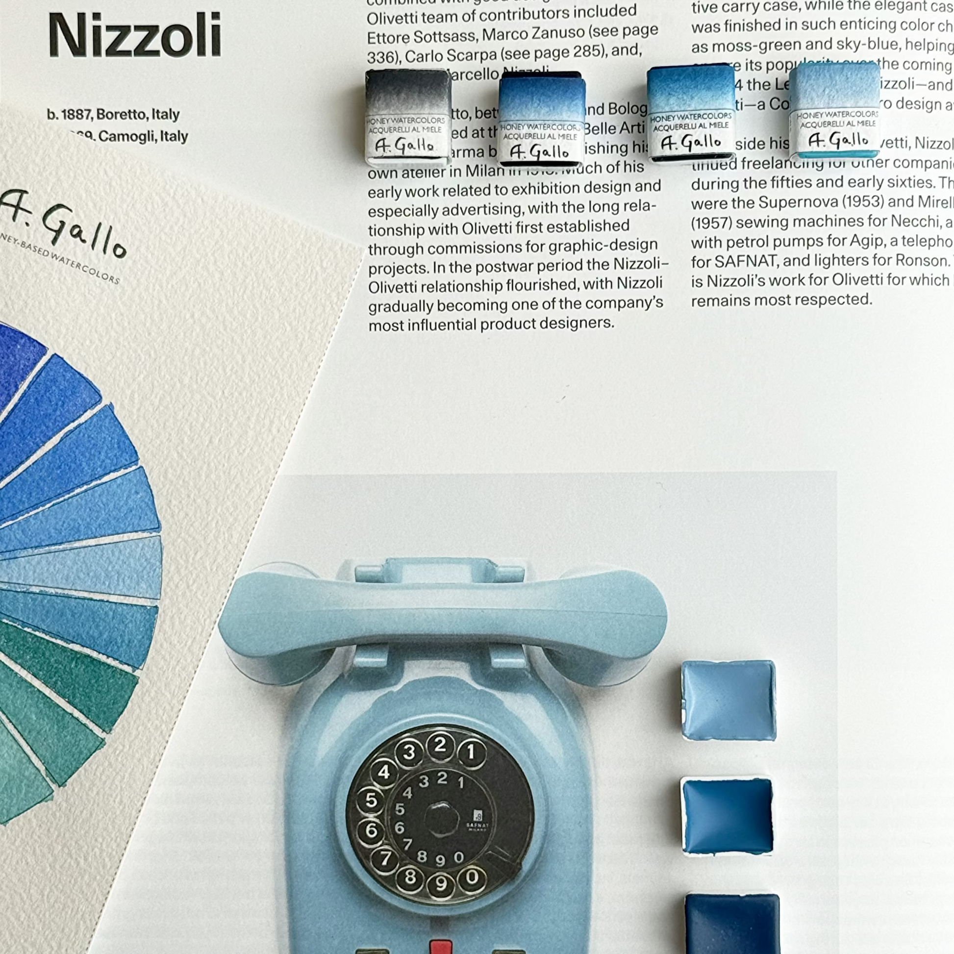 Blue rotary phone with color swatches and text about Marcello Nizzoli on a white background