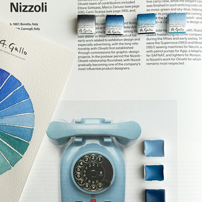 Blue rotary phone with color swatches and text about Marcello Nizzoli on a white background